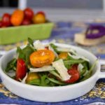 Rocket and tomato salad with shavings of parmesan cheese